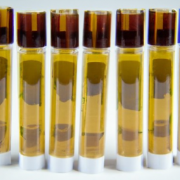 description: a close-up photograph showcasing a collection of amber-colored live resin cartridges. the cartridges are neatly arranged on a white background, highlighting their vibrant and enticing colors. the labels on the cartridges indicate different strain names and the potency of each product. the image exudes a sense of sophistication and quality, inviting viewers to explore the world of live resin.