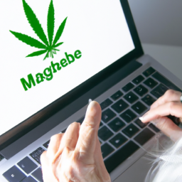 A person using a laptop to access a website with a medical marijuana logo.