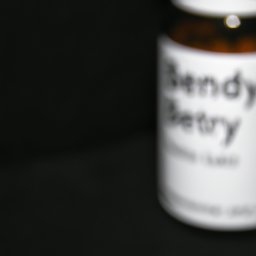 description: a blurred image of a pill bottle with the label "benadryl" visible. the background is dark, and the image is slightly tilted.